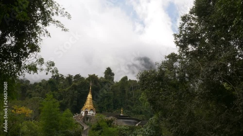 Golden temple shrine in the mountain. Wat Tham Pha Plong, Chiang Dao, Thailand TIME LAPSE COPY SPACE photo