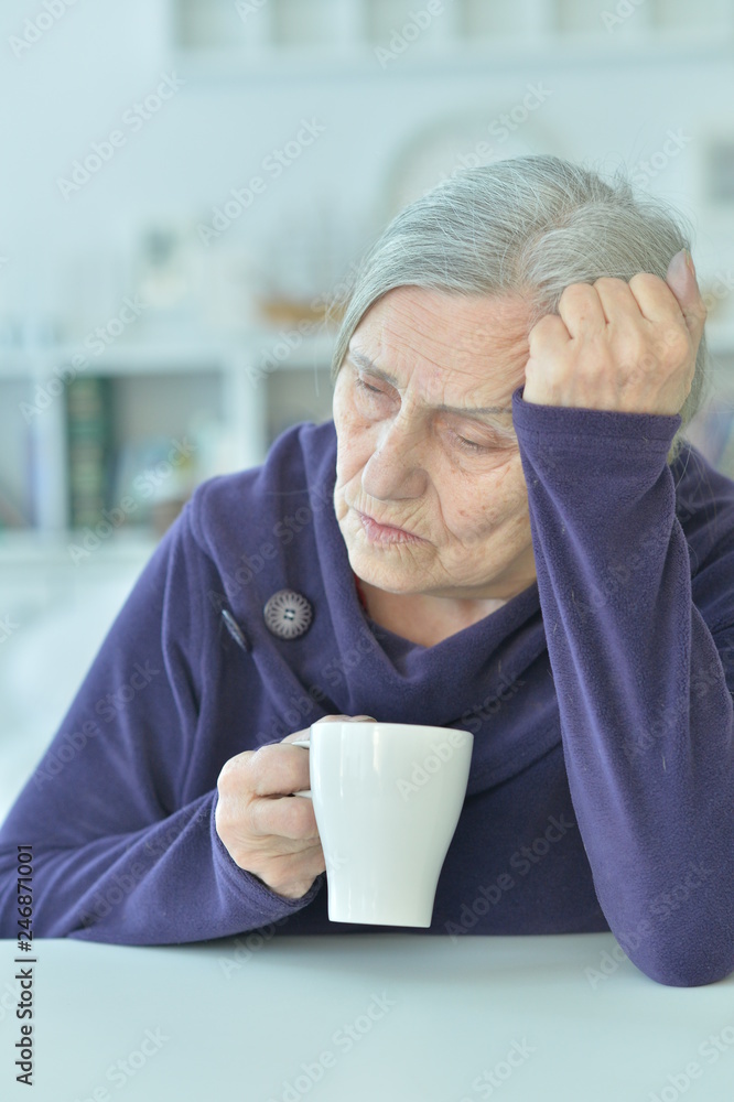Portrait of a sad old woman drinking tea Portrait of a sad old woman drinking tea