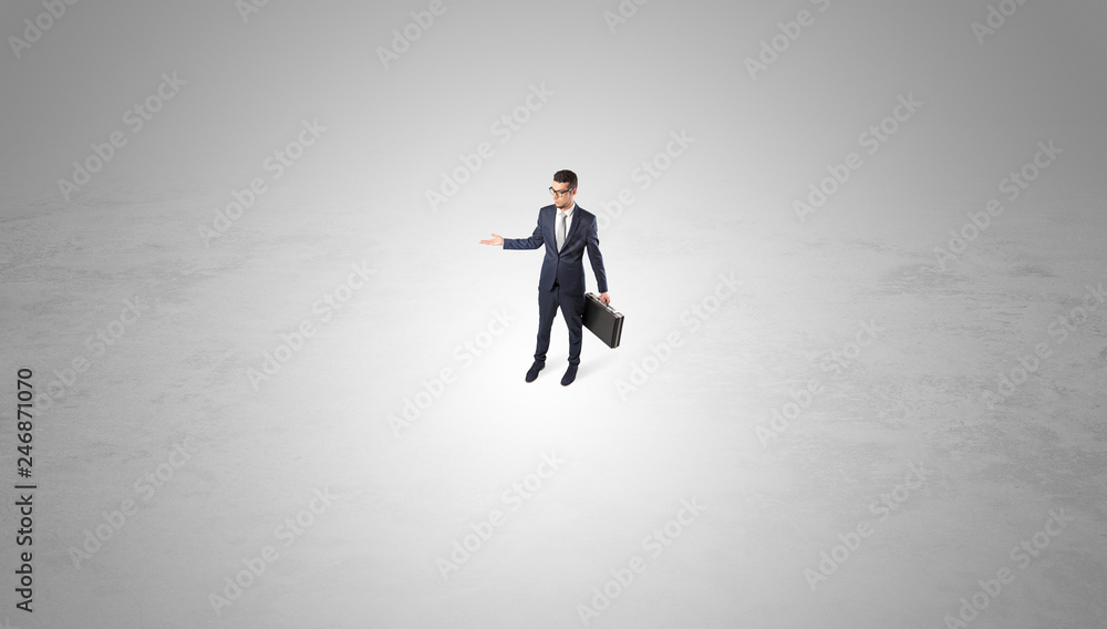 Young businessman standing alone in the middle of an empty space
Young businessman standing alone in the middle of an empty space