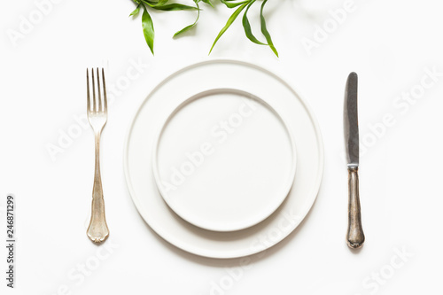 Minimal modern table setting on white. View from above. View from above.