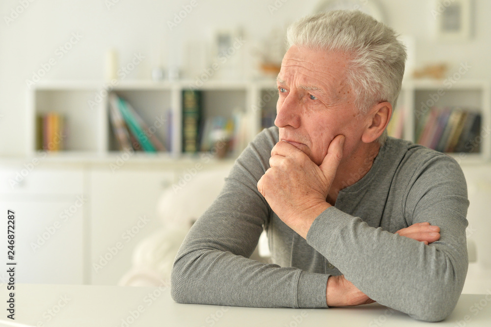 portrait of thoughtful senior man at home portrait of thoughtful senior man at home