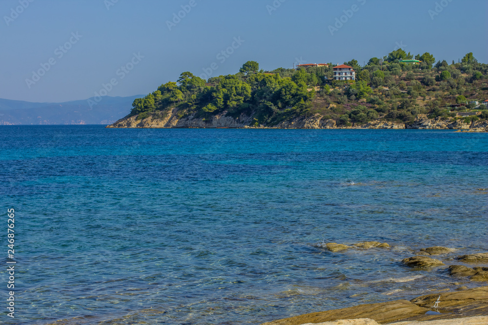 Fototapeta premium Mediterranean sea outdoor scenic landscape photography with vivid blue water surface foreground and opposite island coast line view 