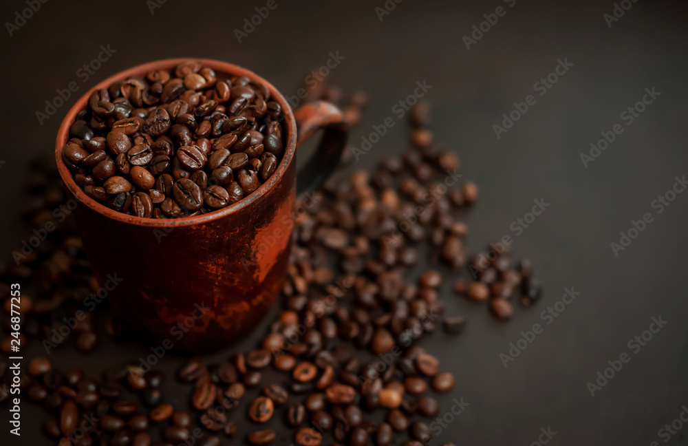 Coffee cup with coffee beans on a stone background