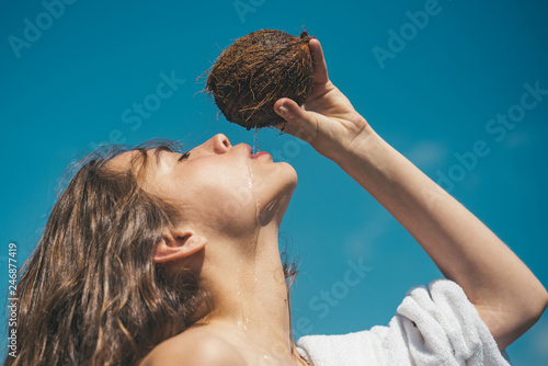 coconut oil. coco milk. Clean eating diet, vegetarian and vegan. Woman is moisturizing her skin with a coconut cream. drinking beach cocktail. woman drinking coconut juice. summer vacation