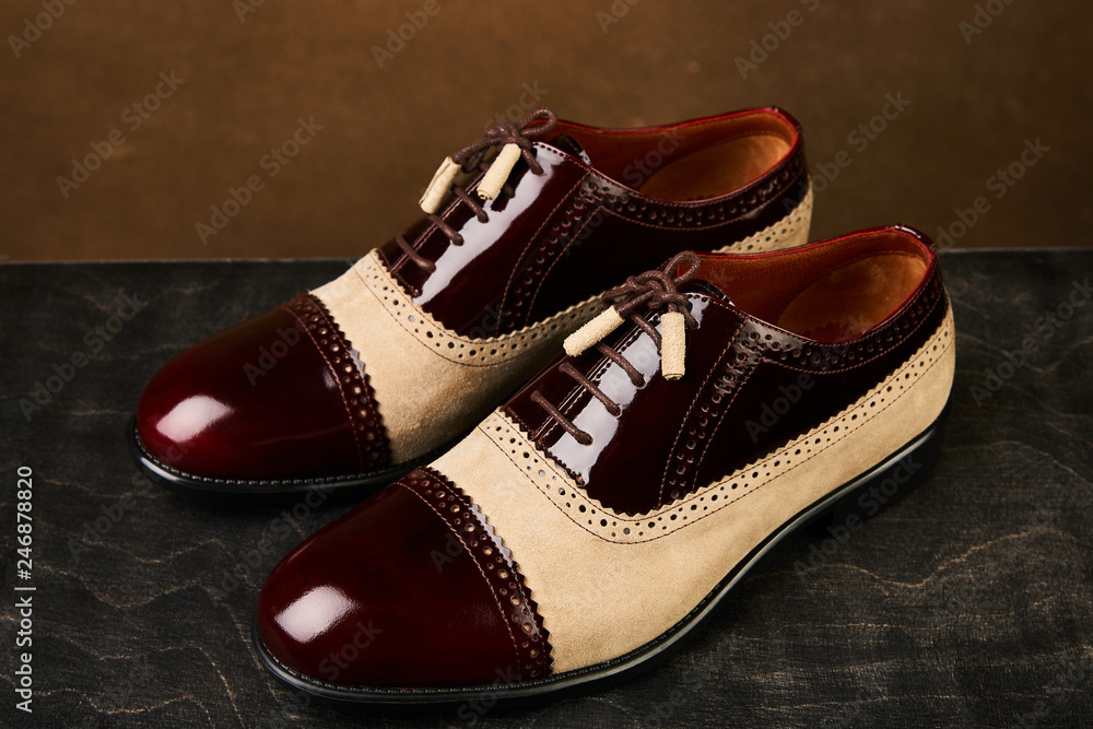 Fototapeta premium Men's wedding shoes on a dark wooden box, close-up