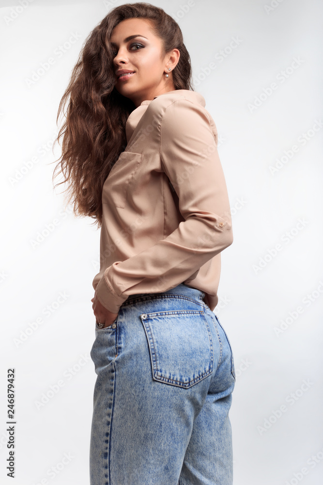 The pretty girl with nice butt. Young woman posing on the camera in studio  in the isolated room on the white background. Model smiling foto de Stock |  Adobe Stock