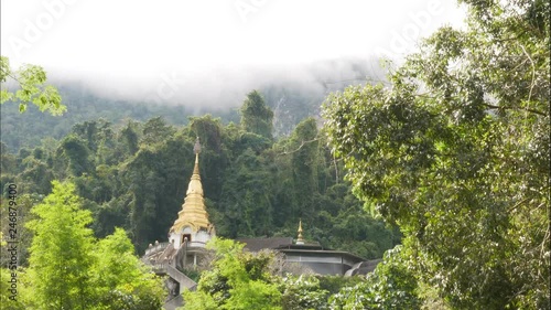 Golden temple shrine in the mountain. Wat Tham Pha Plong, Chiang Dao, Thailand TIME LAPSE photo