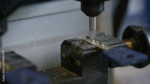 Close shot of locksmith cutting a new key in the workshop photo