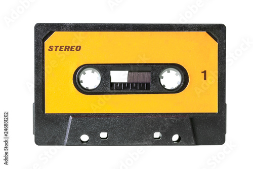 An old vintage cassette tape from the 1980s (obsolete music technology). Black plastic body, canary yellow label with the texts Stereo and 1 (one).