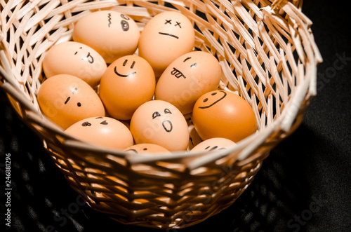 Eggs with smiling faces in the basket