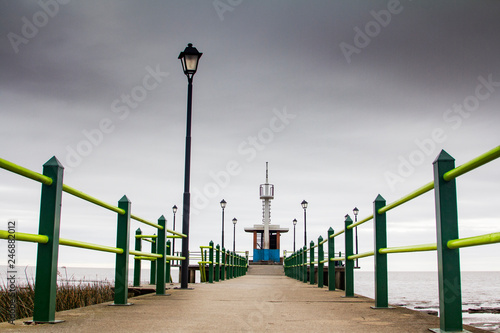 Amazing view of pier with stormy cloudy sky in vanishing point, Buenos Aires Argentina.