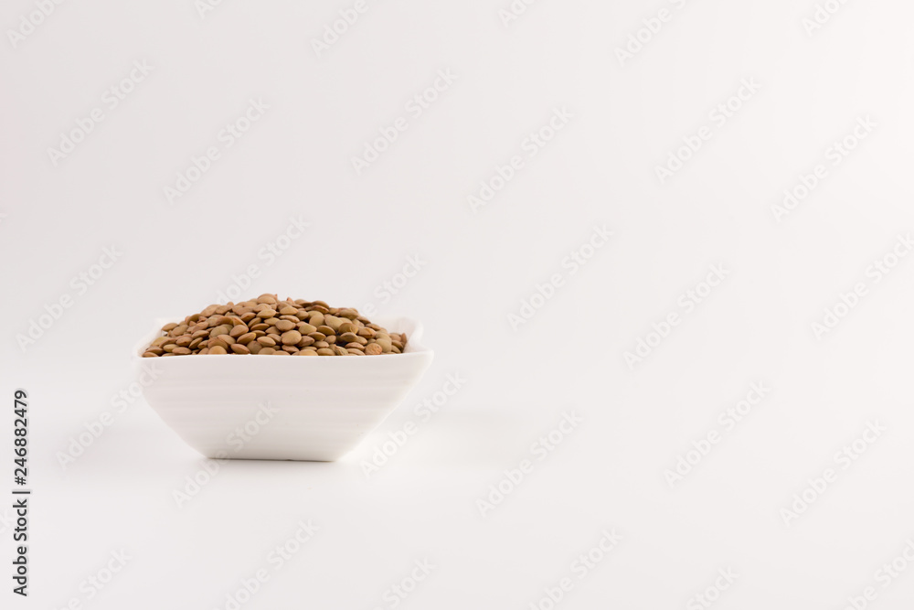 Yellow lentil in a bowl isolated on white background Yellow lentil in a bowl isolated on white background