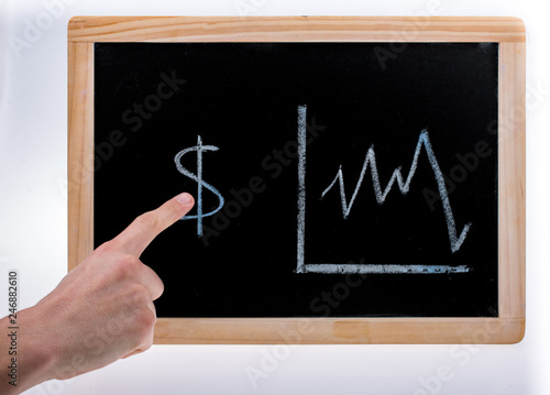 Hand pointing to  American dollars value diagram on a blackboard on white background © EnesBerkay