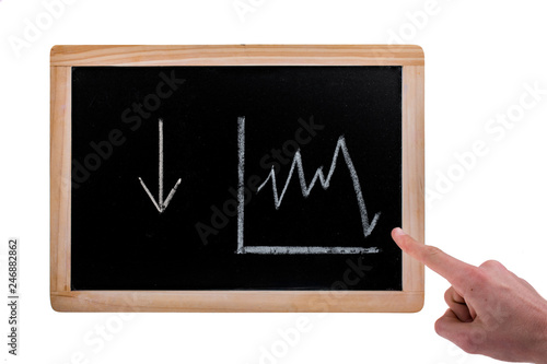 Hand pointing to down arrow and value diagram on a blackboard on white background © EnesBerkay