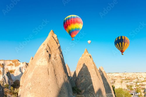 Colorful hot air balloons flying over at fairy chimneys in Nevsehir, Goreme, Cappadocia Turkey. Hot air balloon flight at spectacular Cappadocia Turkey. 