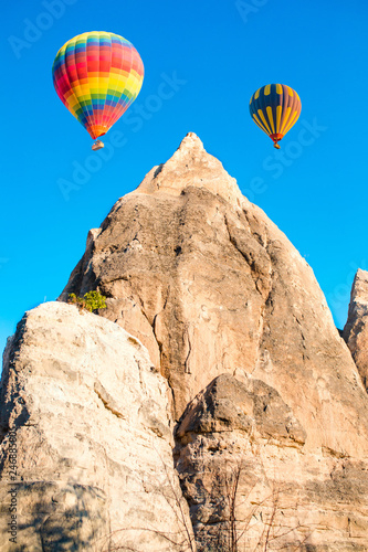 Colorful hot air balloons flying over at fairy chimneys in Nevsehir, Goreme, Cappadocia Turkey. Hot air balloon flight at spectacular Cappadocia Turkey.   © Hakan Tanak