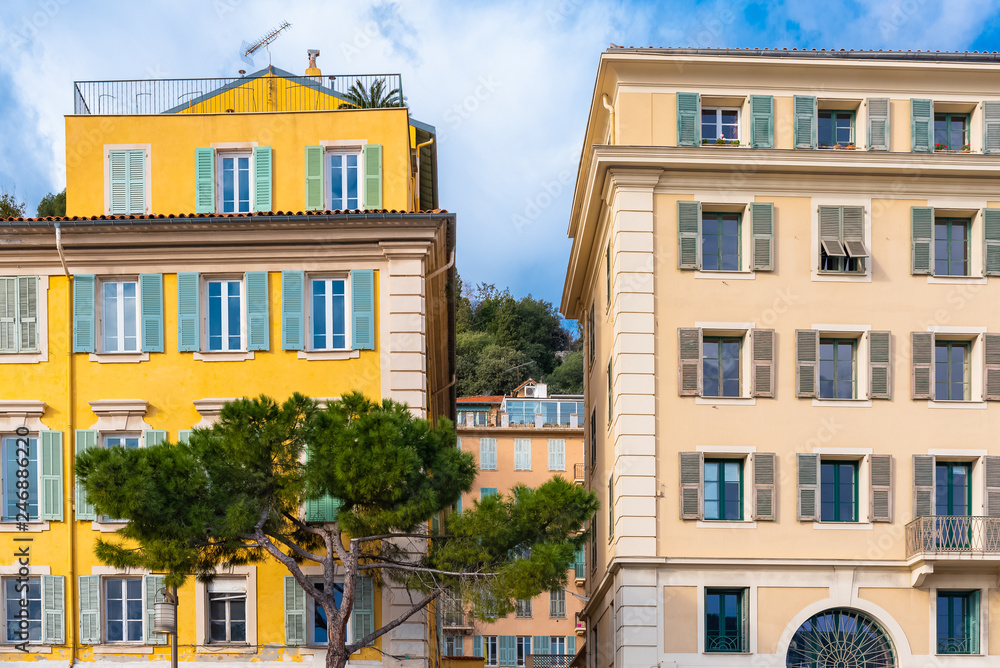 Obraz premium Nice in France, colorful facade, with typical windows and green shutters