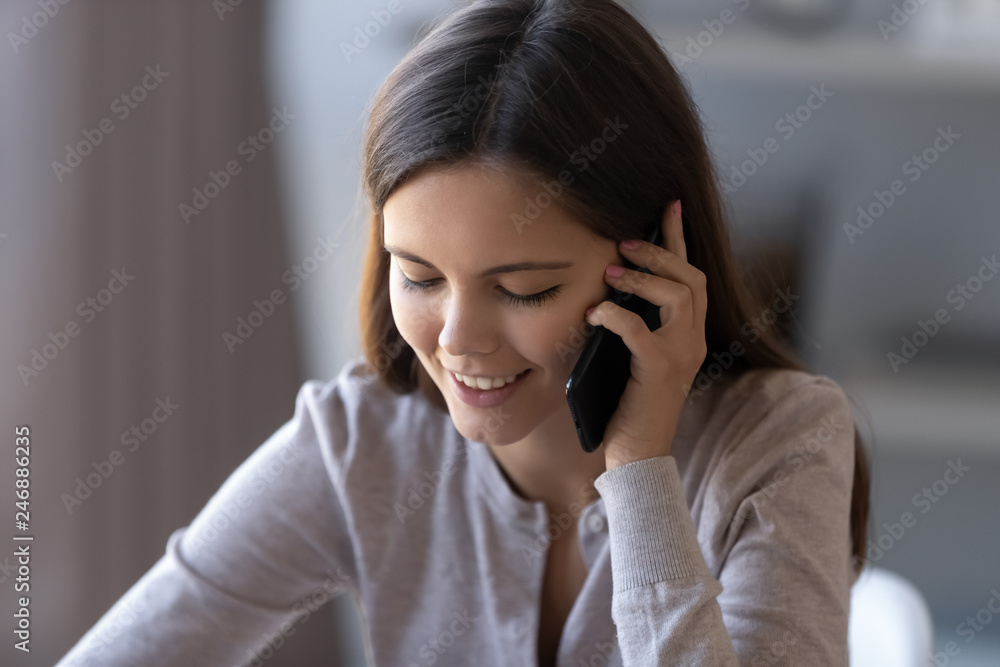 Happy teen girl holding cellphone talking on the phone having pleasant