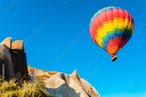 Colorful hot air balloon flying over at fairy chimneys in Nevsehir, Goreme, Cappadocia Turkey. Hot air balloon flight at spectacular Cappadocia Turkey. 
