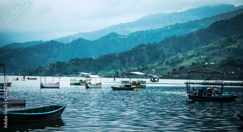 Landscape with boats on the water of Phewa lake, Nepal