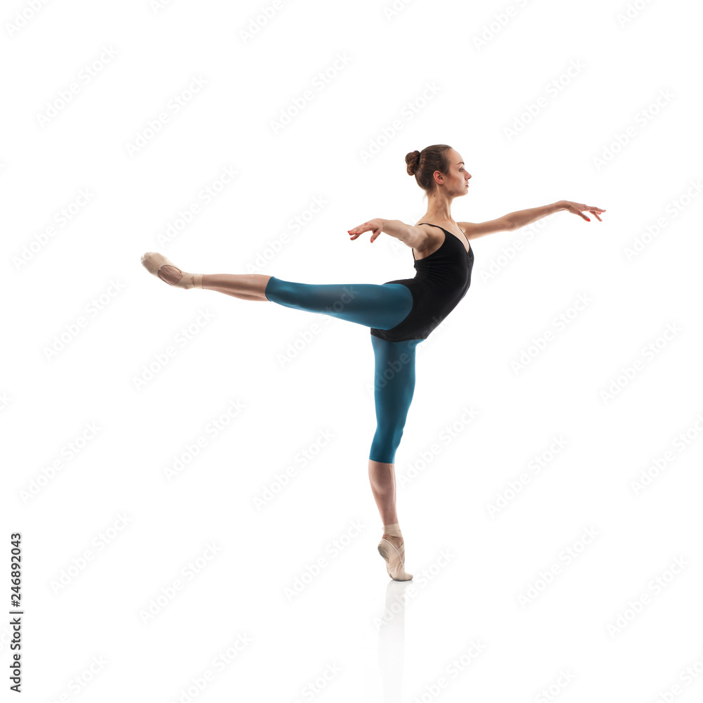 Ballerina in black outfit posing on toes.