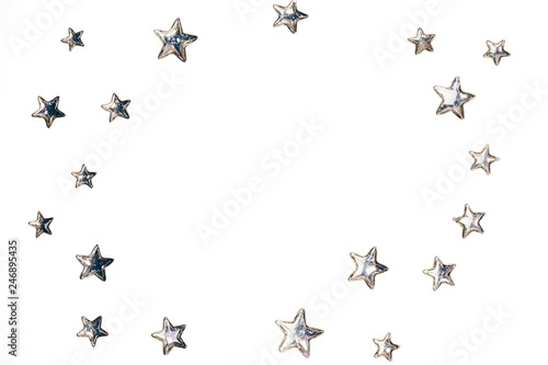 Beautiful shining silver stars with embossed transparent top arranged in circle on isolated white background. Copy space. Top view.