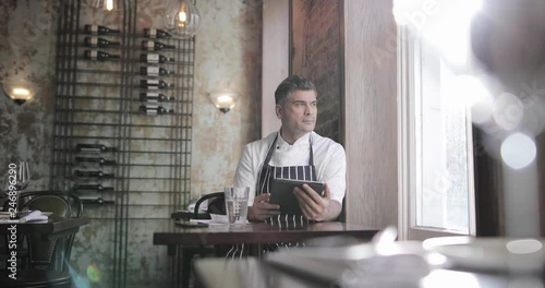Male restaurant owner thinking about expansion