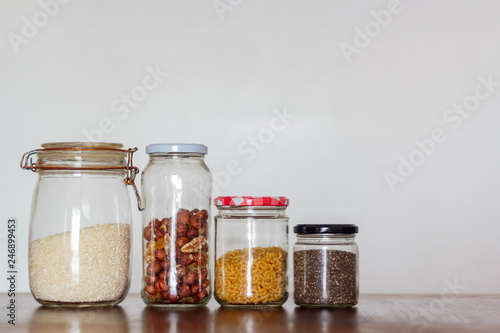 Food in glass jars on wooden table with copy space. Zero Waste, plastic free concept