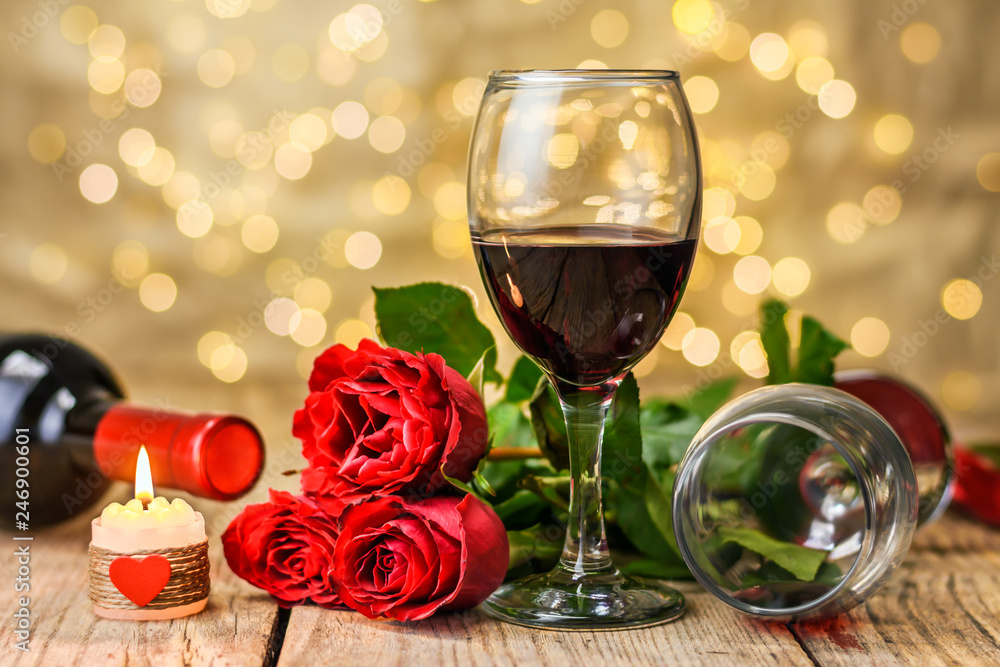 A glasses of wine, roses and burning candle A glasses of wine, roses and burning candle