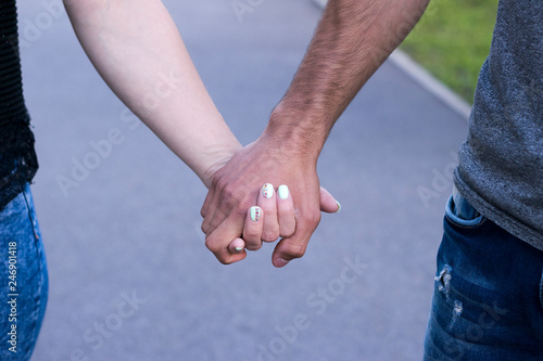 Close up of couple in love holding each other hands