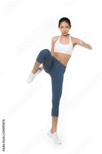 Asian Tan Skin Fitness woman exercise wear blue bra pant suit gear jump kick boxing in the air white background, studio lighting copy space isolated, concept Woman Can Do Sport