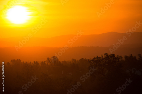 Wallpaper Mural Hazy colorful mountain sunrise in Redding California, with orange, red and yellow colors Torontodigital.ca