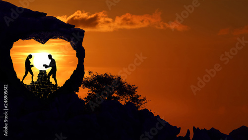 Couple on the heart shape rock on the mountain with red sky sunset.