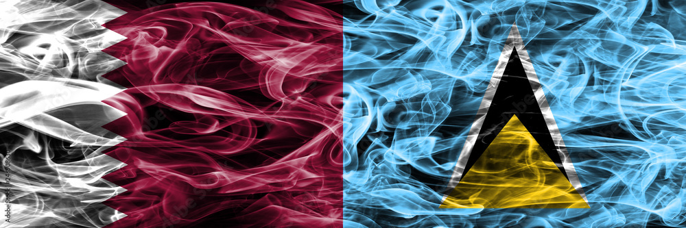 Obraz premium Qatar vs Saint Lucia smoke flags placed side by side. United Arab Emirates. UAE.