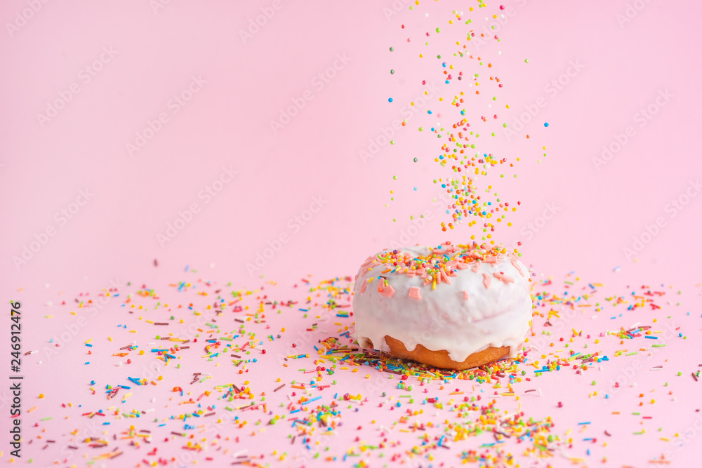 Sprinkle pink donut. on a pink background with space for design. Banner