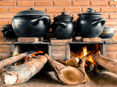 Traditional Brazilian food of Minas Gerais region being prepared in popular wood stove and clay pots - São Thomé das Letras