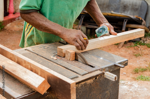 Cabinetmaker Cutting Wood With Old Industrial Saw photo