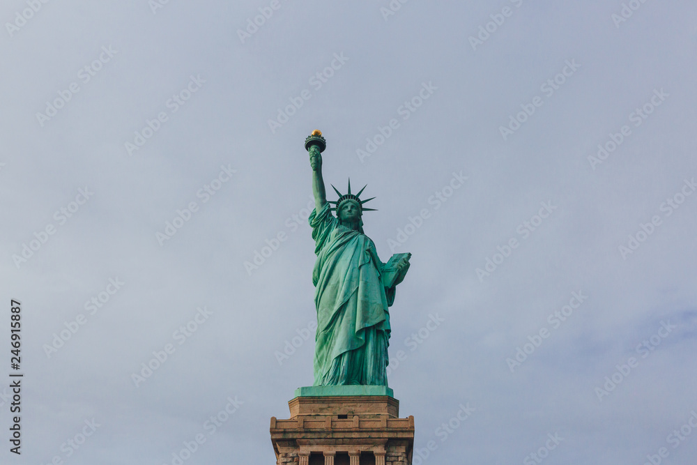 Fototapeta premium Statue of Liberty against sky and clouds, in New York City, USA