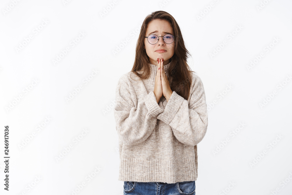 Please help me I need you. Portrait of concerned and sorrow girl in glasses  holding hands