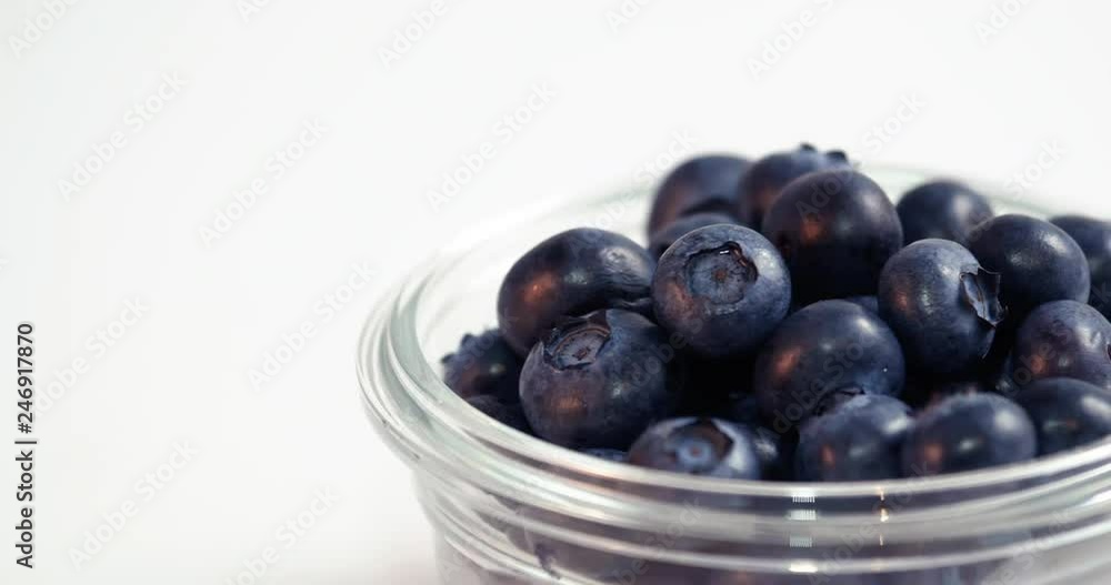 Blueberries in Glass Bowl Moving Across White Background Loop Blueberries in Glass Bowl Moving Across White Background Loop