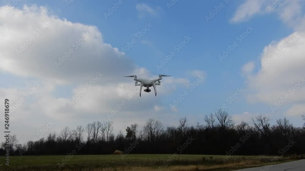 4 K Phantom Drone Hovering Approaching Then Backing Away Against Forest And Bluesky White Clouds Backdrop 4 K Phantom Drone Hovering Approaching Then Backing Away Against Forest And Bluesky White Clouds Backdrop