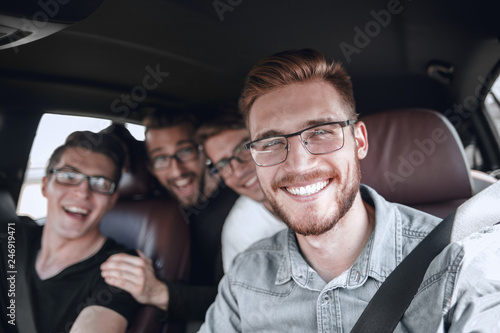 four friends traveling in the car