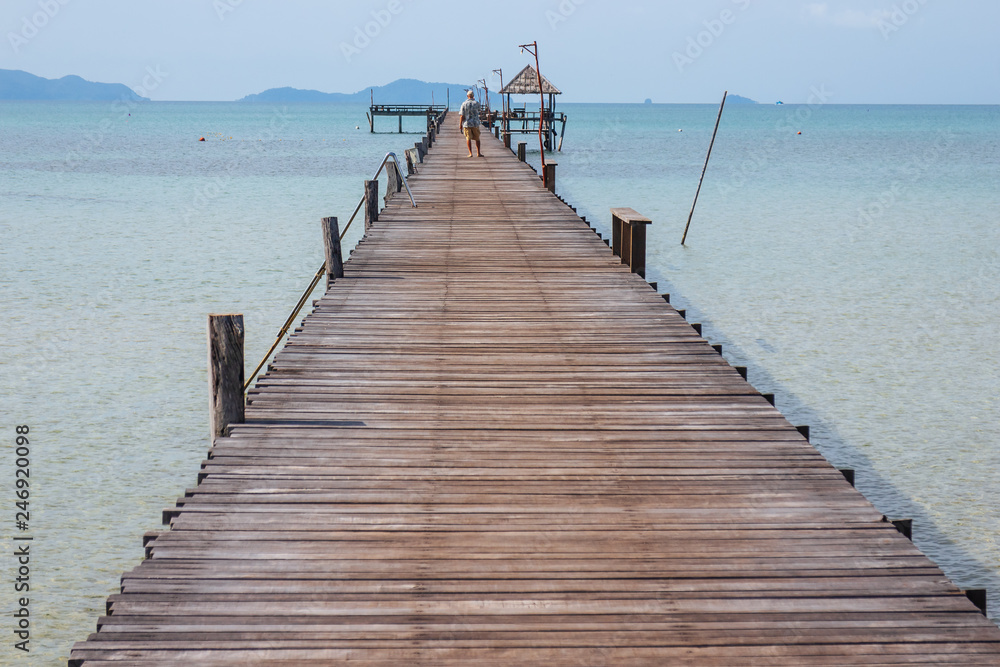 Wooden walkway that lead to the sea from the beach in summer in Koh Mak Island at Trat, Thailand.