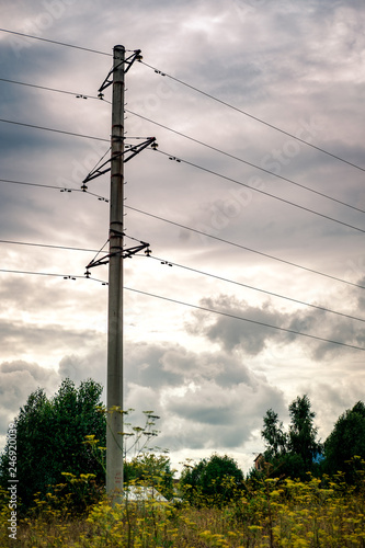 concrete pole with high voltage electric wires in the field