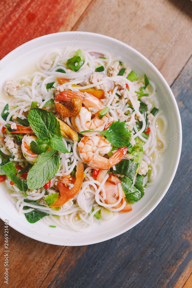 Top view of Spicy rice vermicelli with shrimp, minced pork and chili. Topping with mint leaves. Top view of Spicy rice vermicelli with shrimp, minced pork and chili. Topping with mint leaves.