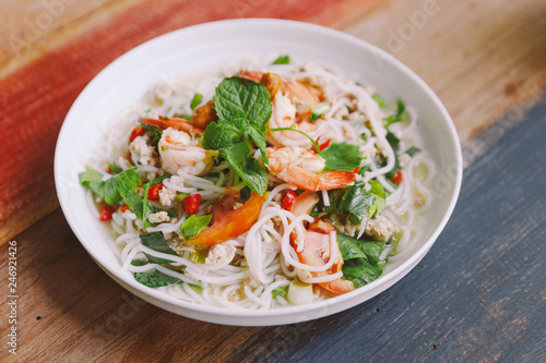 Spicy rice vermicelli with shrimp, minced pork and chili. Topping with mint leaves.