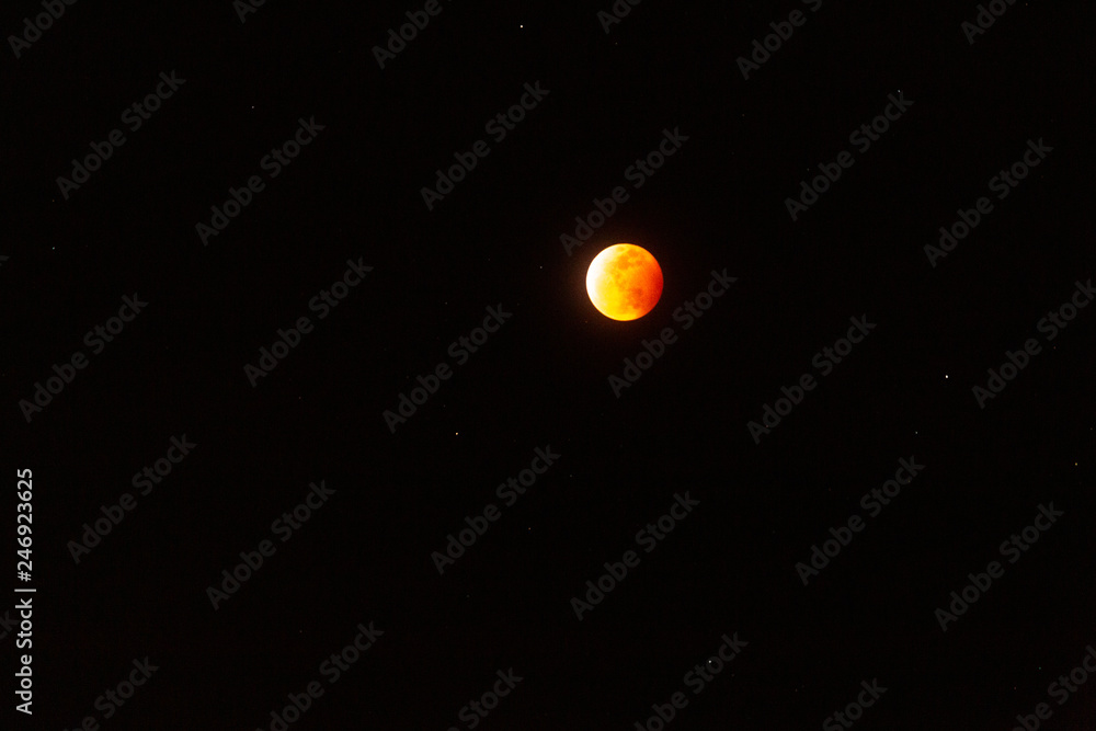 The full Lunar Eclipse in January of 2019 shows the moon in full eclipse and pictures a orangey, red moon glowing in the sky with a section on the edge with whiteish light from the glow of the sun. The full Lunar Eclipse in January of 2019 shows the moon in full eclipse and pictures a orangey, red moon glowing in the sky with a section on the edge with whiteish light from the glow of the sun.