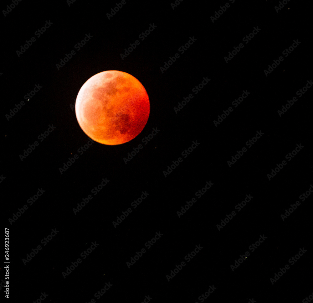 The full Lunar Eclipse in January of 2019 shows the moon in full eclipse and pictures a orangey, red moon glowing in the sky with a section on the edge with whiteish light from the glow of the sun. The full Lunar Eclipse in January of 2019 shows the moon in full eclipse and pictures a orangey, red moon glowing in the sky with a section on the edge with whiteish light from the glow of the sun.