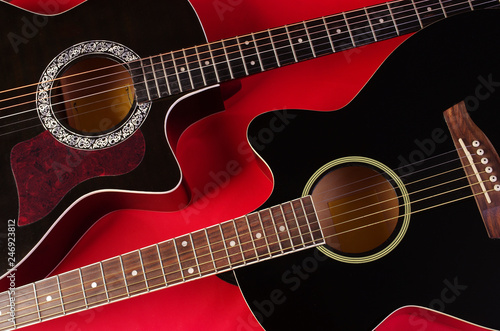 Two acoustic guitars on red