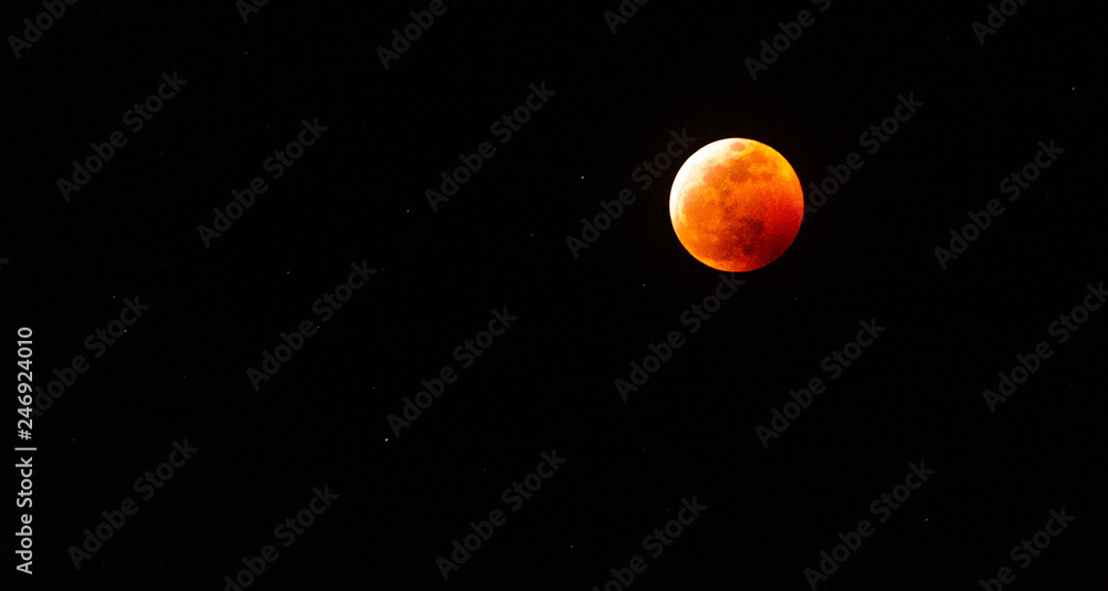 The full Lunar Eclipse in January of 2019 shows the moon in full eclipse and pictures a orangey, red moon glowing in the sky with a section on the edge with whiteish light from the glow of the sun. The full Lunar Eclipse in January of 2019 shows the moon in full eclipse and pictures a orangey, red moon glowing in the sky with a section on the edge with whiteish light from the glow of the sun.